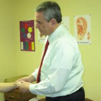 Dr. John M. DiVelbiss Chiropractor ico